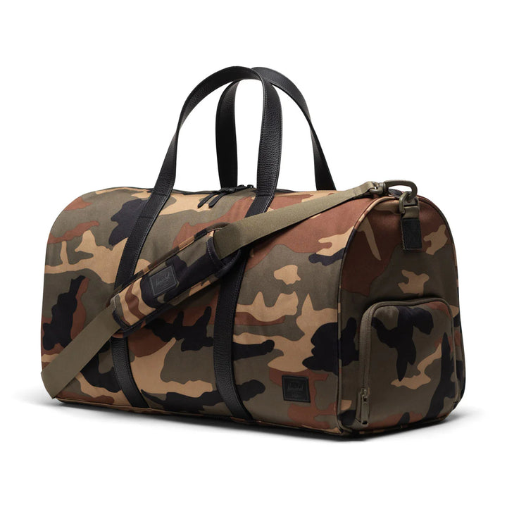 Herschel - Herschel Novel™ Duffle in Woodland Camo Black Label