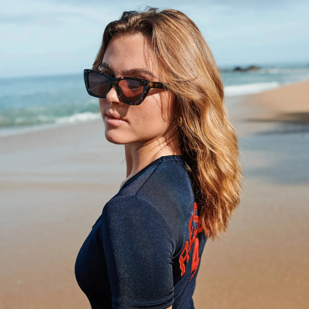 Cate with Tortoise Frames and Plum Polarized Lenses